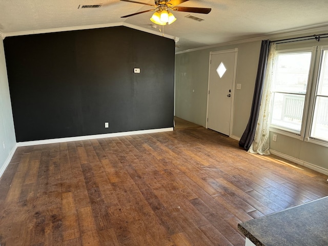 interior space featuring lofted ceiling, ceiling fan, wood-type flooring, and visible vents