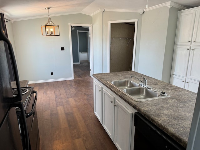 kitchen featuring black appliances, dark countertops, a sink, and white cabinetry