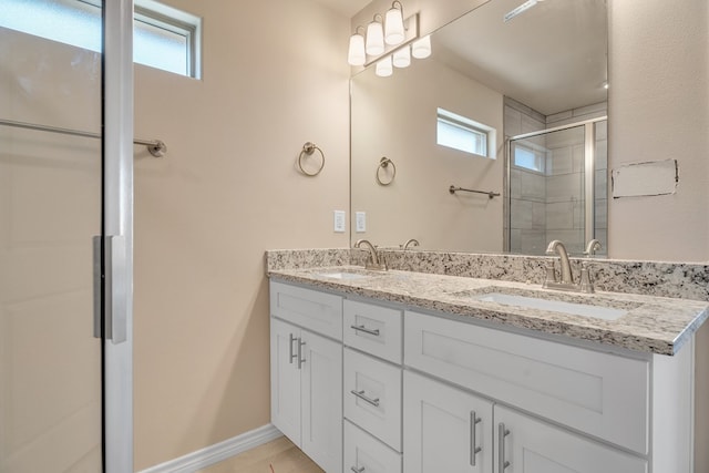 bathroom with a healthy amount of sunlight, an enclosed shower, and vanity