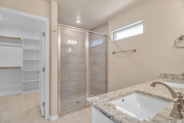 bathroom featuring vanity and a shower with shower door