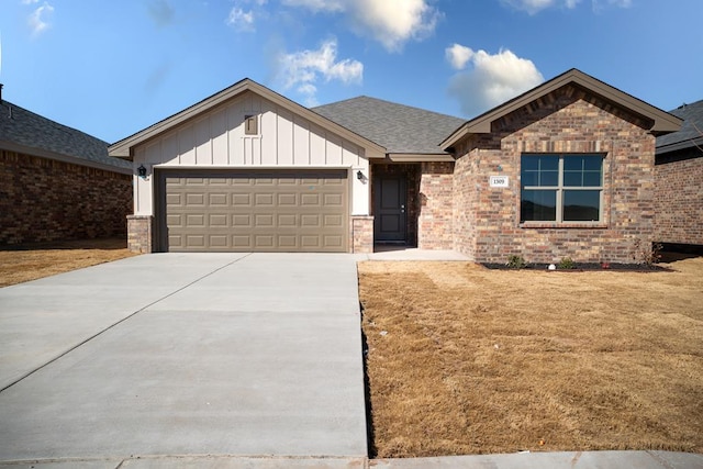 view of front of property with a garage and a front yard