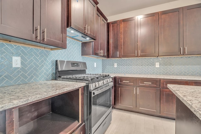 kitchen with extractor fan, tasteful backsplash, light wood-type flooring, stainless steel range with gas cooktop, and light stone countertops