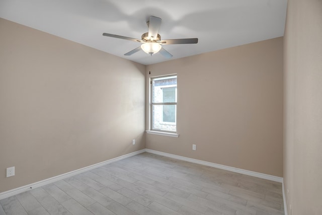 spare room featuring ceiling fan and light hardwood / wood-style flooring