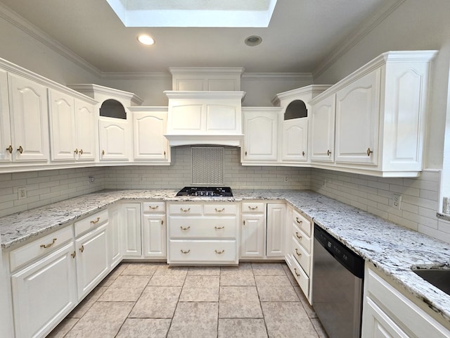 kitchen featuring white cabinetry, a skylight, stainless steel dishwasher, and decorative backsplash