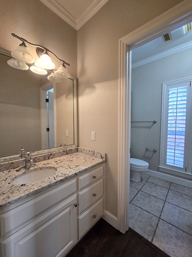 bathroom featuring toilet, tile patterned flooring, ornamental molding, and vanity