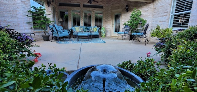 view of patio with ceiling fan and an outdoor living space