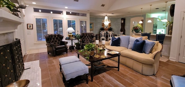 living room with lofted ceiling and ornamental molding