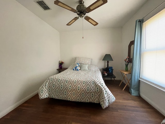 bedroom with hardwood / wood-style flooring, multiple windows, and visible vents