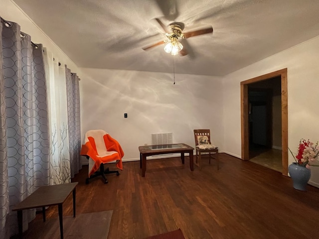 sitting room featuring visible vents, a textured ceiling, a ceiling fan, and wood finished floors