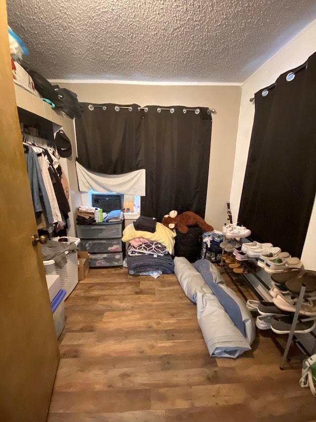 bedroom featuring a textured ceiling and hardwood / wood-style flooring