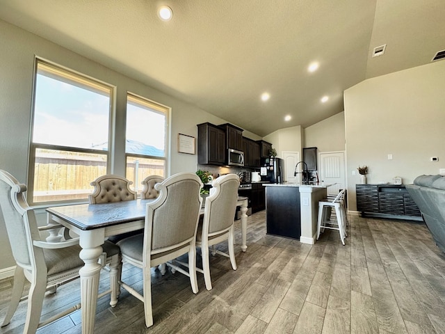 6005 Scaled Quail Rd, Midland, TX 79707 - dining space featuring light wood finished floors, recessed lighting, and high vaulted ceiling