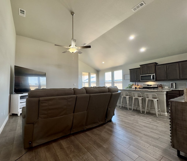 6005 Scaled Quail Rd, Midland, TX 79707 - living room with dark wood-style floors, ceiling fan, and high vaulted ceiling