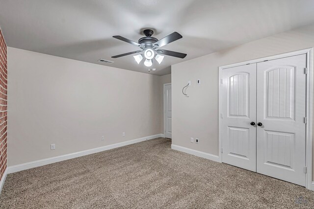 unfurnished bedroom featuring carpet flooring, ceiling fan, and a closet