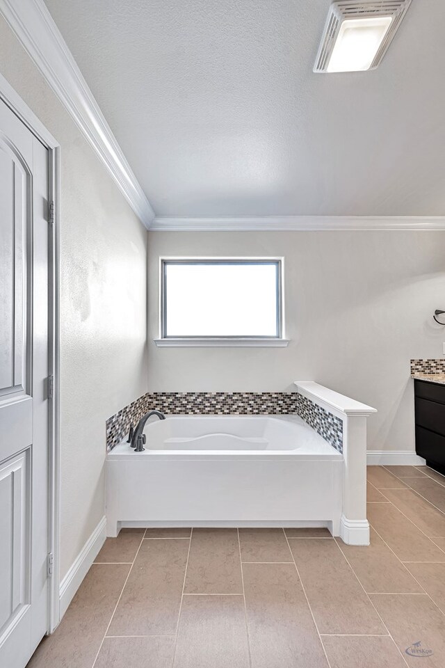 bathroom with tile patterned floors, vanity, a bath, and ornamental molding