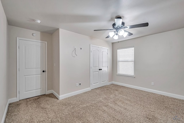 unfurnished bedroom with ceiling fan and light carpet