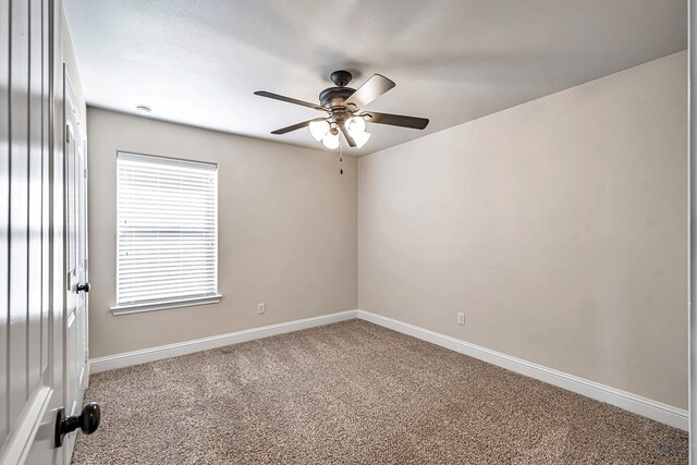 empty room with carpet flooring and ceiling fan