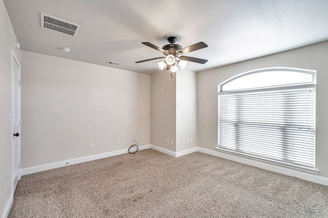 carpeted empty room featuring ceiling fan