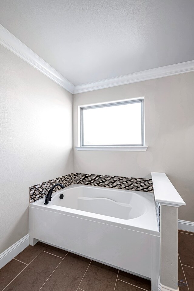 bathroom featuring tile patterned floors, plenty of natural light, a bathtub, and crown molding