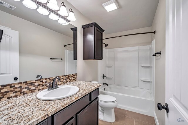 full bathroom featuring backsplash, shower / bathtub combination, vanity, tile patterned flooring, and toilet