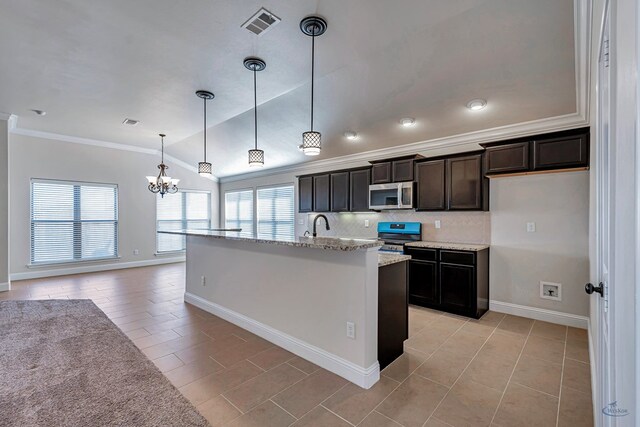 kitchen with a center island with sink, vaulted ceiling, ornamental molding, appliances with stainless steel finishes, and decorative light fixtures