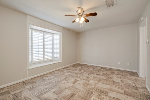 unfurnished room featuring ceiling fan, visible vents, and baseboards