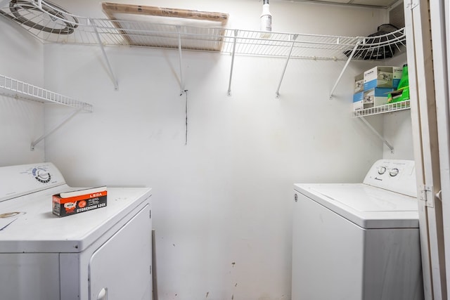 clothes washing area with separate washer and dryer