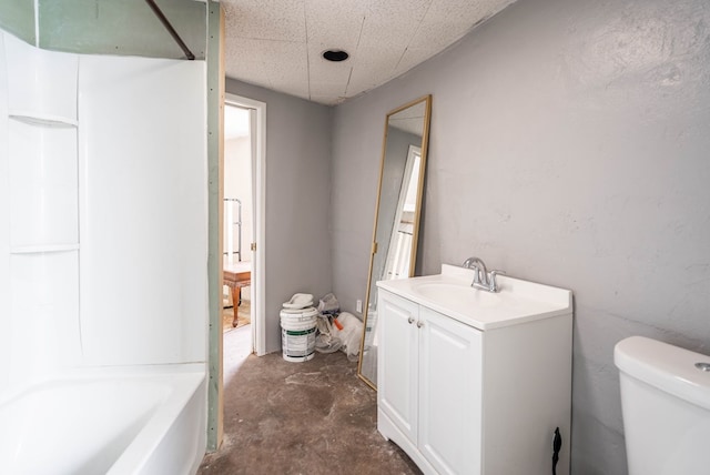 bathroom with toilet, concrete flooring, and vanity