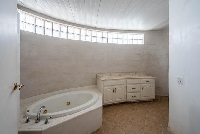 bathroom with vanity, tile patterned floors, and a relaxing tiled tub