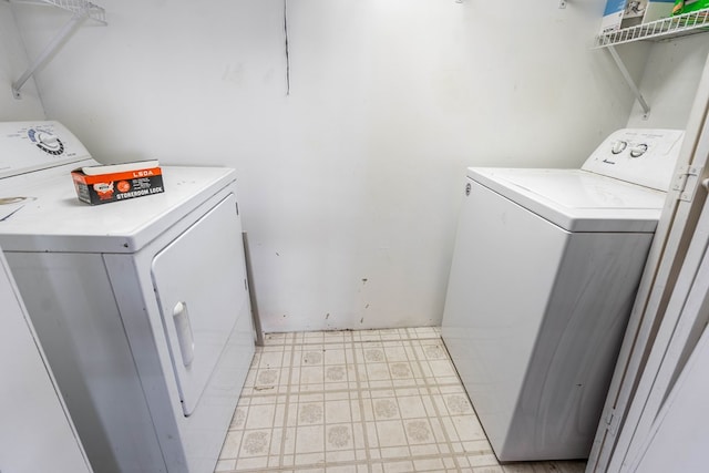 clothes washing area featuring independent washer and dryer