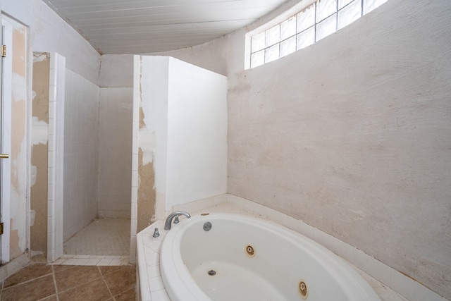 bathroom with tile patterned floors and independent shower and bath