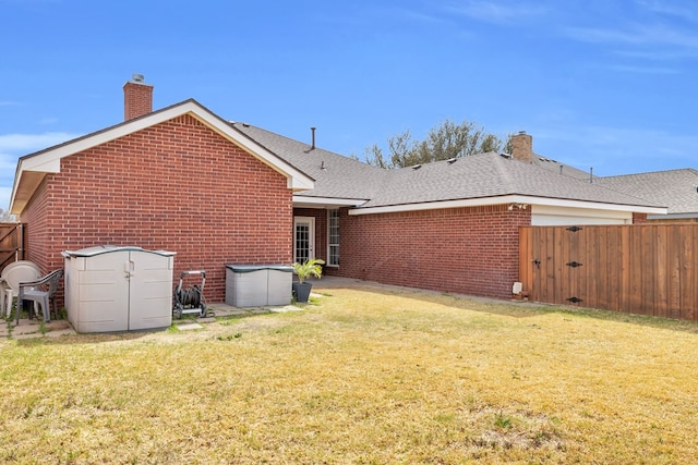 5502 Sundance Ct, Midland, TX 79707 - back of property with a chimney, brick siding, a gate, and a shingled roof