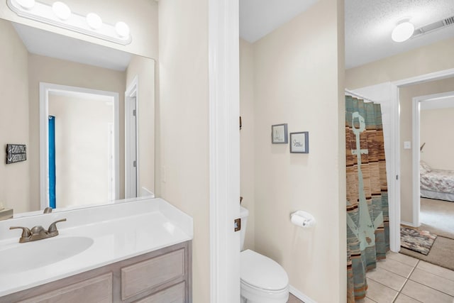 5502 Sundance Ct, Midland, TX 79707 - ensuite bathroom with vanity, toilet, tile patterned floors, curtained shower, and baseboards