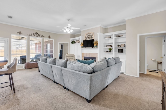 5502 Sundance Ct, Midland, TX 79707 - living room featuring light carpet, ornamental molding, ceiling fan, a tiled fireplace, and baseboards