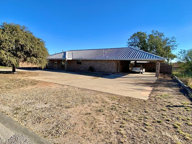 back of house featuring a carport