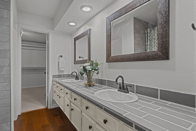 bathroom with vanity, hardwood / wood-style flooring, and a textured ceiling