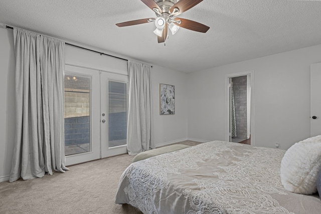 bedroom with ceiling fan, access to exterior, a textured ceiling, light colored carpet, and french doors