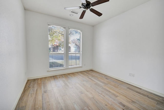 empty room featuring ceiling fan and light wood-type flooring