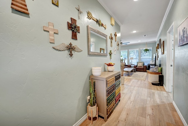 hall featuring ornamental molding and light wood-type flooring