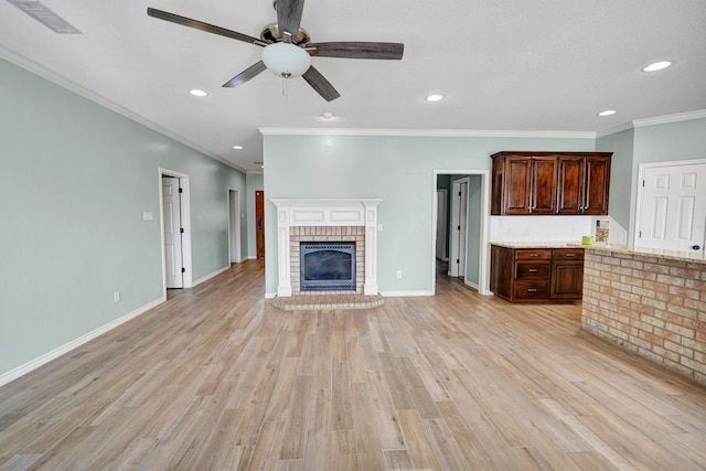 unfurnished living room featuring a fireplace, ceiling fan, and light wood-type flooring