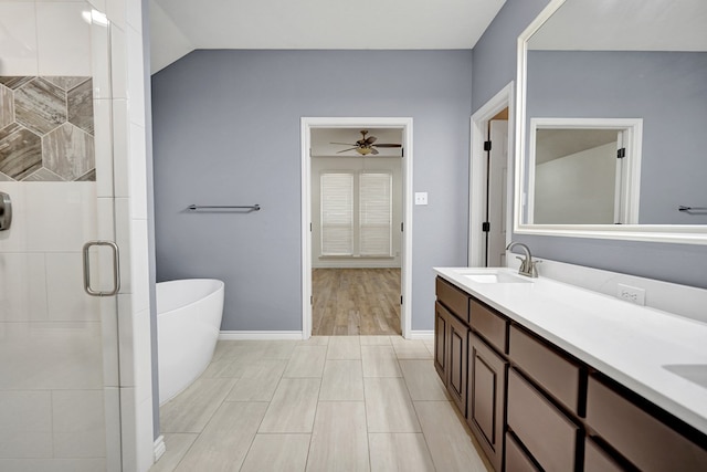 bathroom with vanity, lofted ceiling, shower with separate bathtub, and ceiling fan