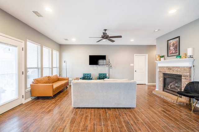 3505 Coquina Ln, Midland, TX 79707 - living area featuring a brick fireplace, wood finished floors, recessed lighting, baseboards, and a ceiling fan