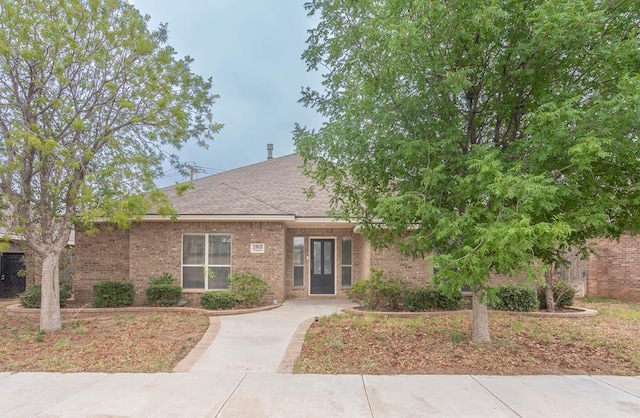 3505 Coquina Ln, Midland, TX 79707 - view of front of property with brick siding and a shingled roof