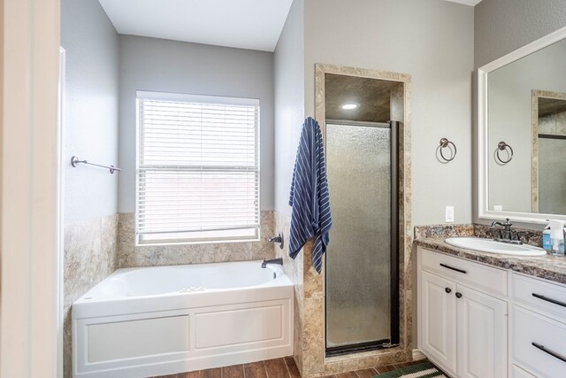 3505 Coquina Ln, Midland, TX 79707 - bathroom with a shower stall, a bath, vanity, and plenty of natural light