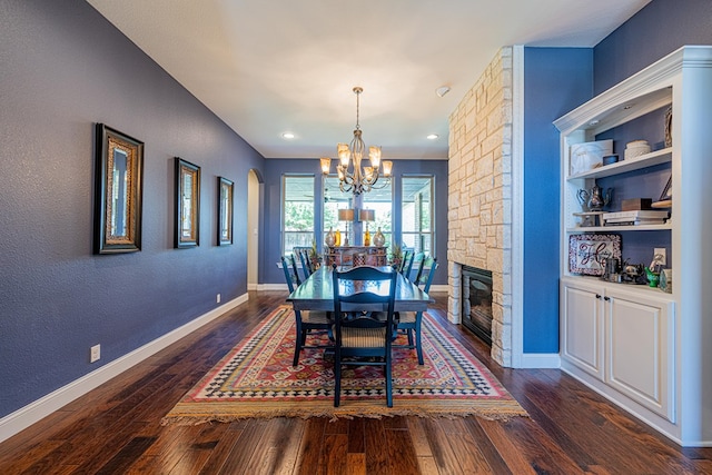 dining area with baseboards, dark wood-type flooring, and a notable chandelier