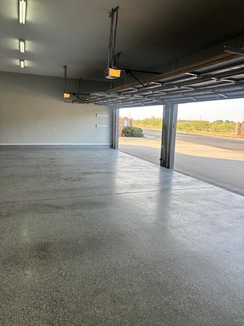 900 Keystone Ct, Midland, TX 79705 - garage with a garage door opener and baseboards