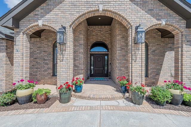property entrance featuring brick siding
