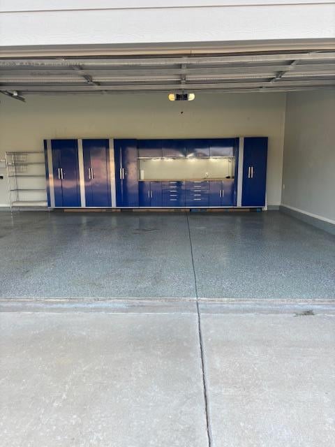 900 Keystone Ct, Midland, TX 79705 - garage with baseboards and a garage door opener