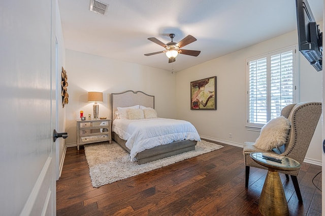 bedroom with baseboards, wood-type flooring, a ceiling fan, and visible vents