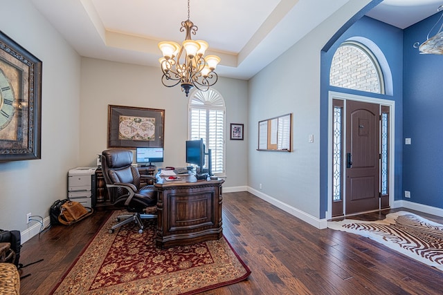 home office with a raised ceiling, baseboards, a notable chandelier, and hardwood / wood-style flooring