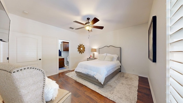 bedroom featuring visible vents, a ceiling fan, dark wood finished floors, and baseboards
